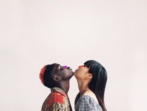 Couple looking up wearing purple and red high spf Zinc Nözscreen on their noses. 